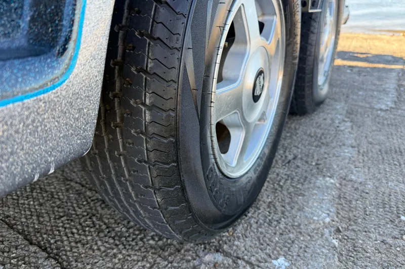 Slide: The Image of Close-up of 2008 Ranger 198 VX trailer tire on textured pavement. - 37
