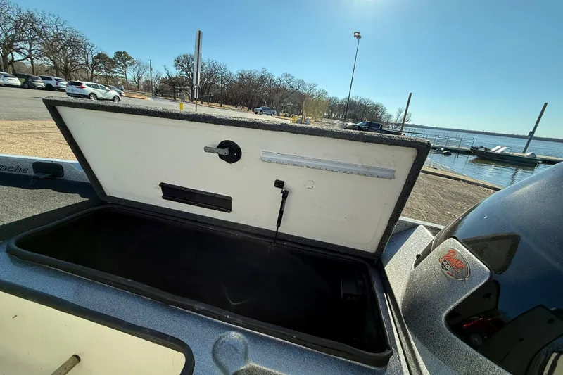 Slide: The Image of Open storage compartment on a 2008 Ranger 198 VX boat by a lakeside. - 44