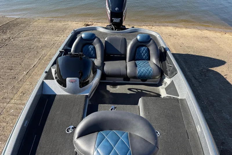 Slide: The Image of 2008 Ranger 198 VX boat interior with blue and black seating, near water. - 50