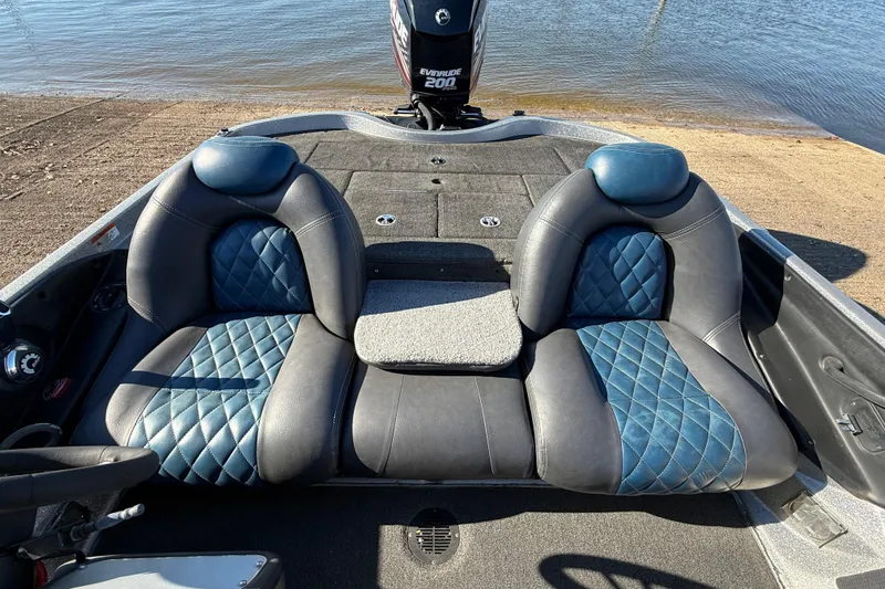 Slide: The Image of 2008 Ranger 198 VX boat interior with blue and black leather seats by the water. - 57