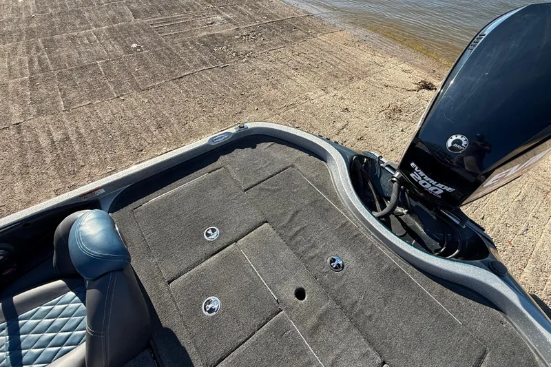 Slide: The Image of 2008 Ranger 198 VX boat with Evinrude 200 engine at a lakeside ramp. - 58