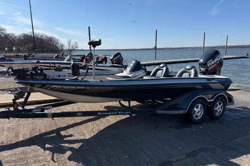 Slide: The Image of 2008 Ranger 198 VX boat on trailer by a lakeside dock. - 6