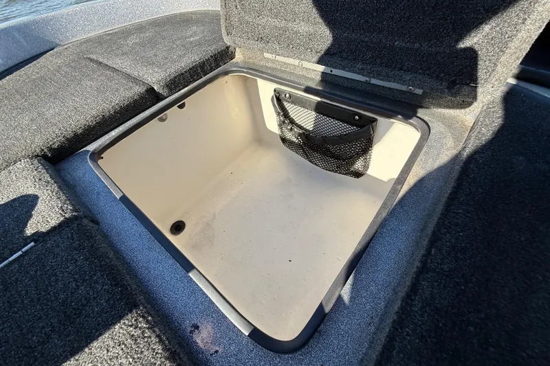 Slide: The Image of Open storage compartment in 2008 Ranger 198 VX boat, featuring a mesh pocket. - 63