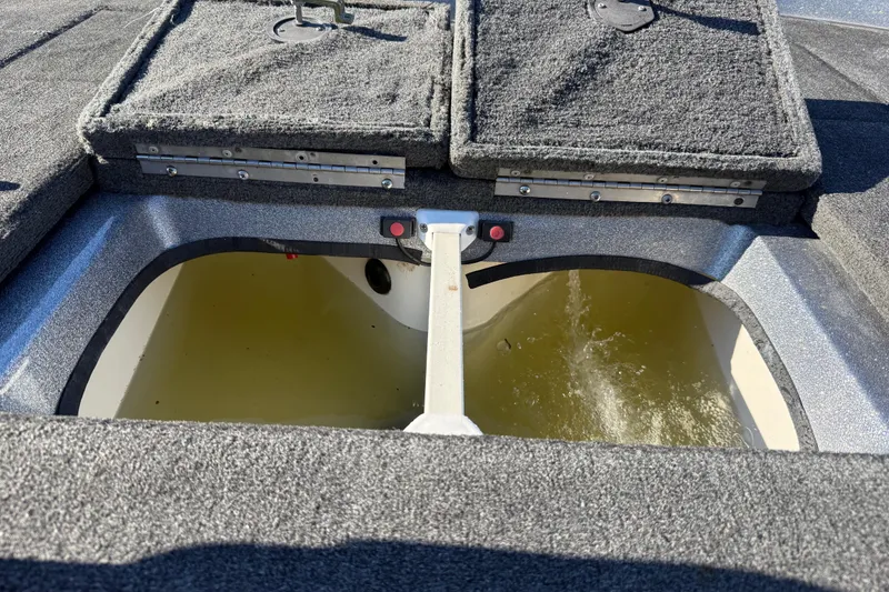 Slide: The Image of 2008 Ranger 198VX Comanche boat livewell with water filling, carpeted deck visible. - 66