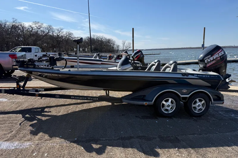Slide: The Image of 2008 Ranger 198 VX boat on trailer by a lakeside, under clear blue sky. - 7
