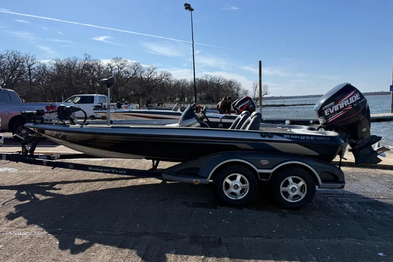 Slide: The Image of 2008 Ranger 198 VX boat with Evinrude motor on trailer by a lake. - 8