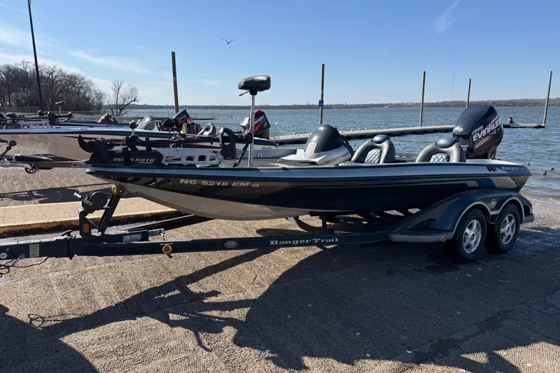 Slide: The Image of 2008 Ranger 198 VX boat on trailer with Evinrude motor, parked near a lake. - 9