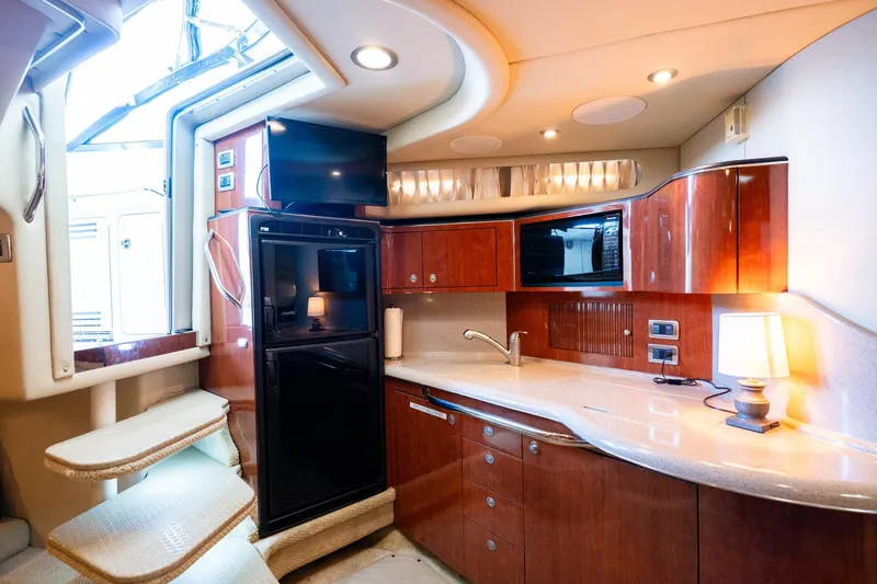 Slide: The Image of Luxurious 2004 Sea Ray 380 Sundancer yacht interior with modern kitchen amenities. - 12