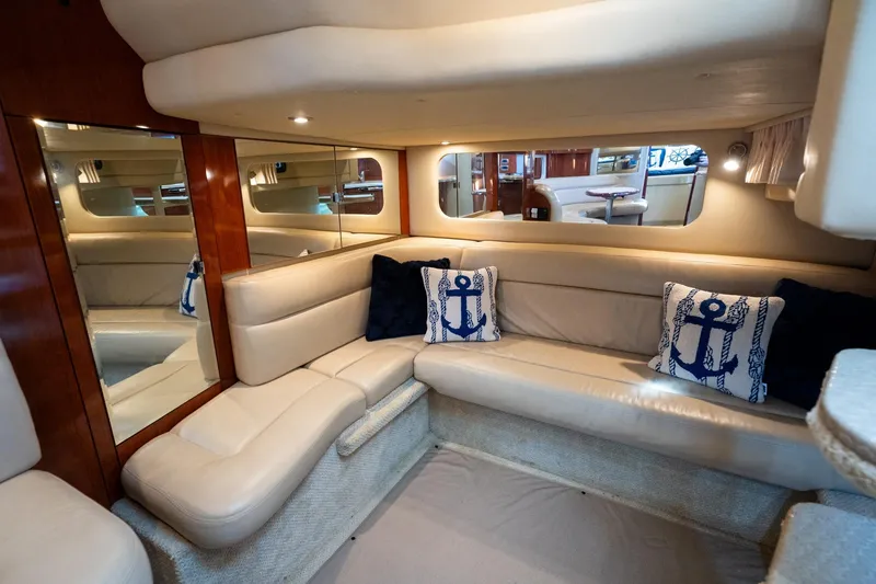 Slide: The Image of Luxurious 2004 Sea Ray 380 Sundancer interior with beige seating and nautical-themed pillows. - 15