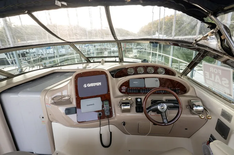 Slide: The Image of 2004 Sea Ray 380 Sundancer helm with Garmin navigation, steering wheel, and control panel. - 22