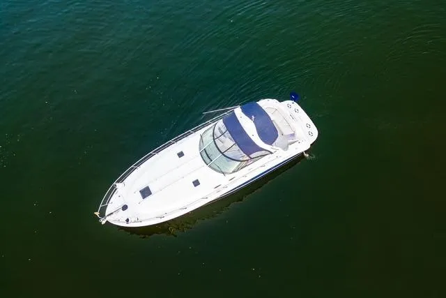 Slide: The Image of 2004 Sea Ray 380 Sundancer yacht on calm green water, aerial view. - 28