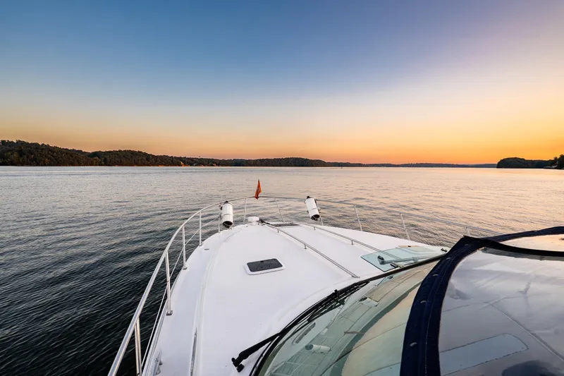 Slide: The Image of 2004 Sea Ray 380 Sundancer cruising at sunset on a tranquil lake. - 7