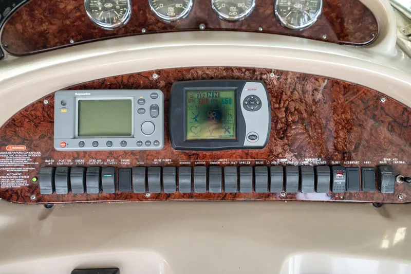 Slide: The Image of Control panel of a 2004 Sea Ray 380 Sundancer with navigation and system switches. - 9