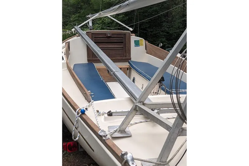 Slide: The Image of 1981 McVay Bluenose sailboat interior with blue seating and wooden accents. - 10
