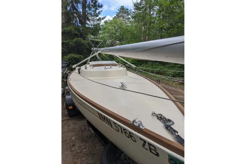 Slide: The Image of 1981 McVay Bluenose sailboat on trailer, surrounded by trees. - 13