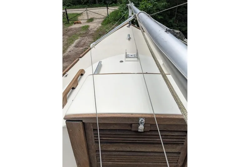 Slide: The Image of 1981 McVay Bluenose sailboat deck with wooden hatch and rigging. - 5