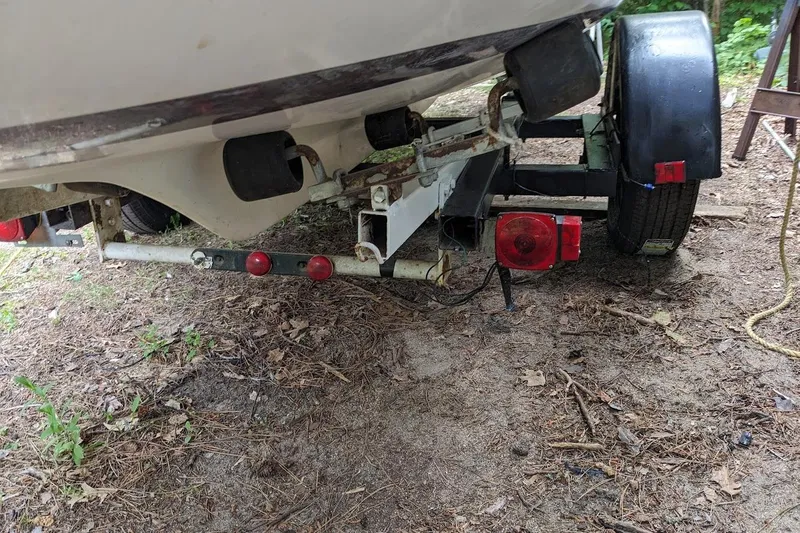 Slide: The Image of 1981 McVay Bluenose boat trailer with red lights, parked on dirt ground. - 6