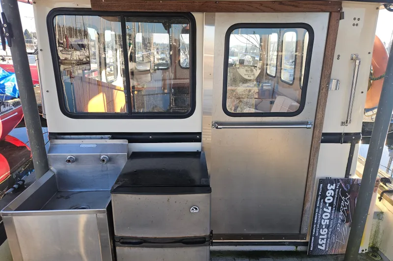 Slide: The Image of 1981 Nordic Tug Cricket boat deck with marina background. - 10