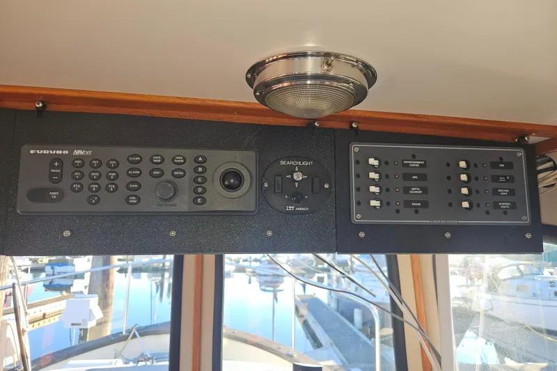 Slide: The Image of 1981 Nordic Tug Cricket interior with helm, seating, and navigation equipment. - 18