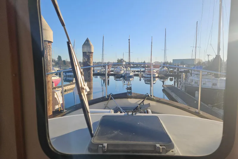 Slide: The Image of 1981 Nordic Tug Cricket helm with gauges, controls, and navigation equipment. - 19