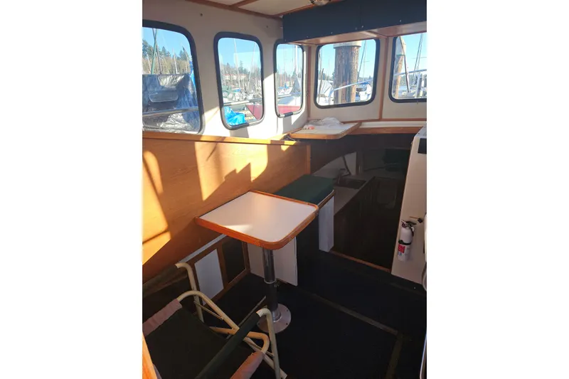 Slide: The Image of Interior view from 1981 Nordic Tug Cricket, overlooking marina through windows. - 25