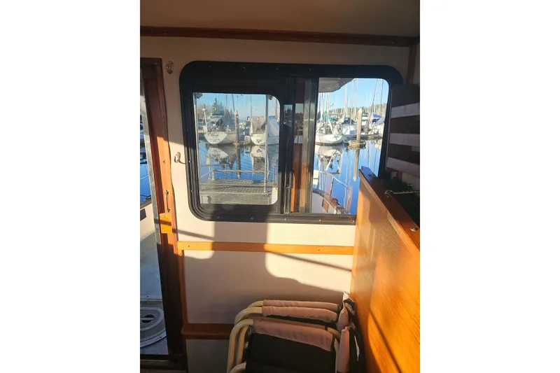 Slide: The Image of Interior of 1981 Nordic Tug Cricket, featuring wooden accents and seating area. - 28