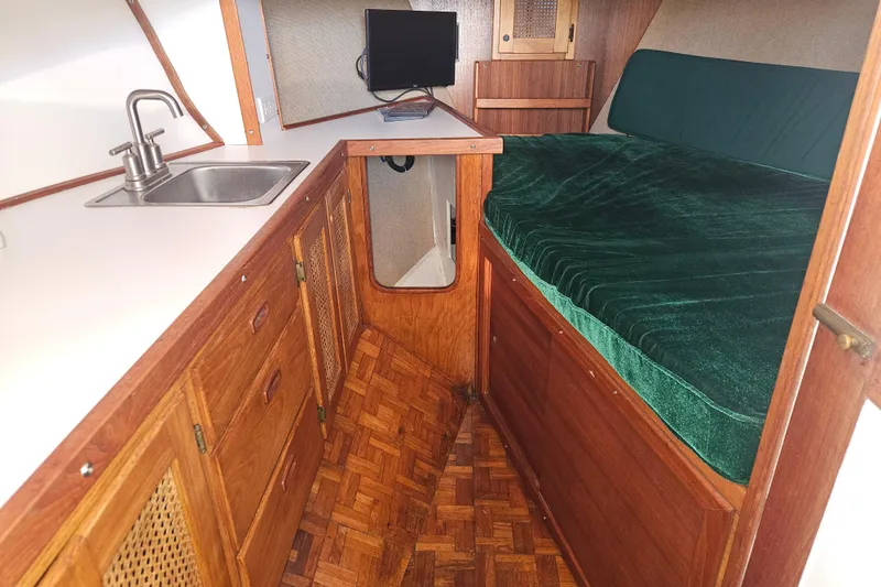 Slide: The Image of Interior view of 1981 Nordic Tug Cricket with marina visible through window. - 31