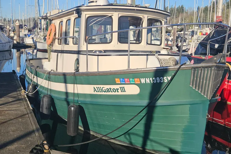 The Image of 1981 Nordic Tug Cricket cruising on a serene lake under a clear blue sky. - 0