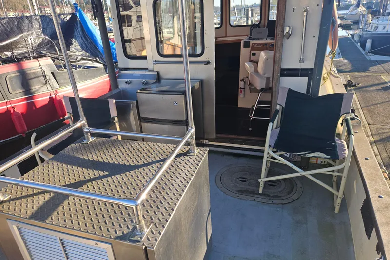 Slide: The Image of 1981 Nordic Tug Cricket with stainless steel sink and door, docked at marina. - 12