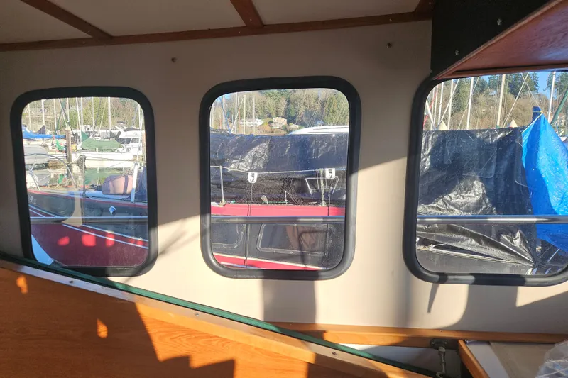 Slide: The Image of View from 1981 Nordic Tug Cricket, overlooking marina with sailboats and clear blue sky. - 21
