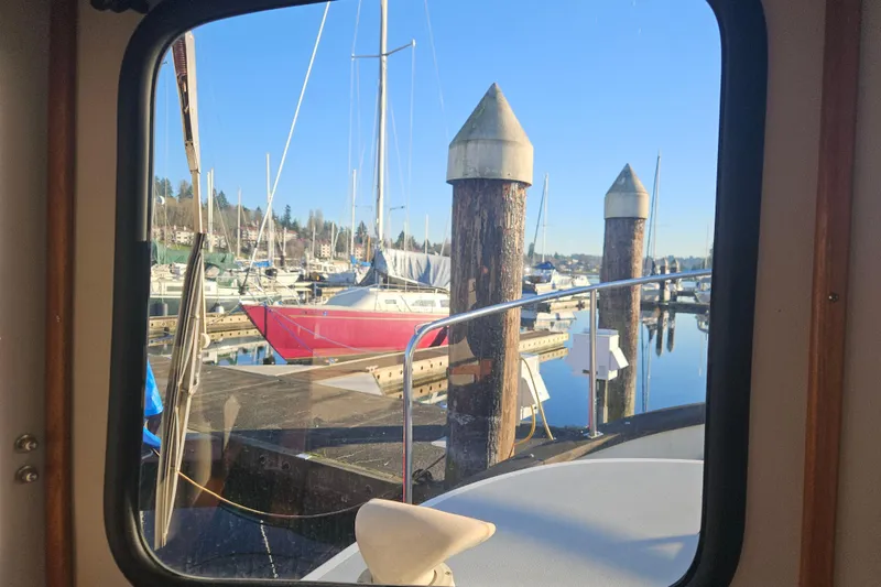 Slide: The Image of 1981 Nordic Tug Cricket on calm waters under clear blue sky. - 23