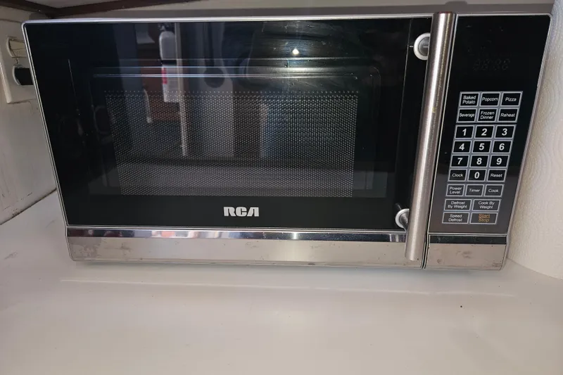 Slide: The Image of 1981 Nordic Tug Cricket bathroom with wooden accents, compact sink, and toilet. - 37