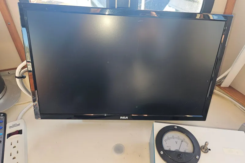 Slide: The Image of VHF marine radio on 1981 Nordic Tug Cricket boat, featuring distress button and microphone. - 45