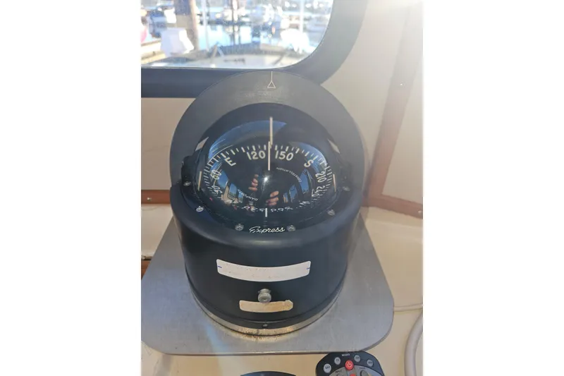 Slide: The Image of Garmin GPSMAP 700 series owner's manual on a spiral-bound cover. Nordic Tug Cricket 1981. - 47