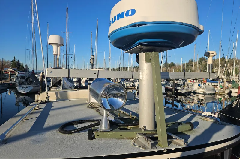 Slide: The Image of 1981 Nordic Tug Cricket boat with radar and spotlight in a marina. - 67