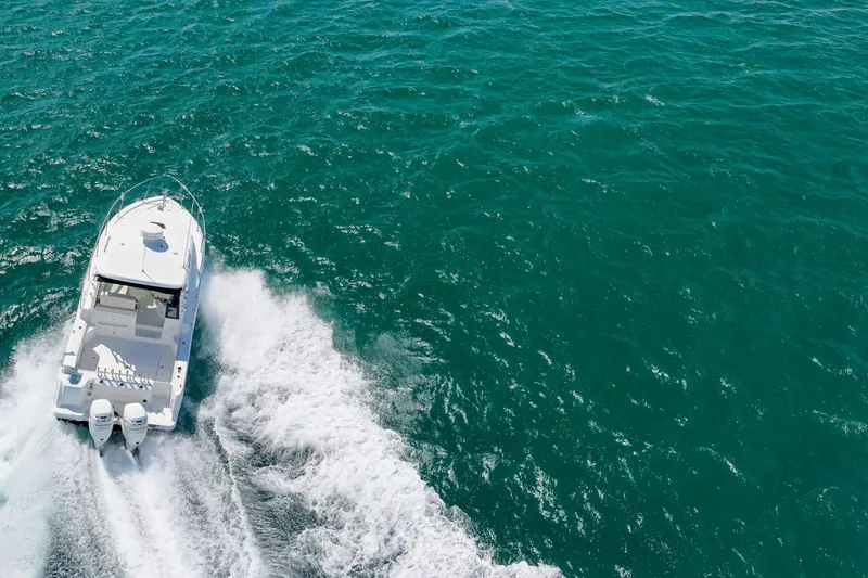 Slide: The Image of 2018 Boston Whaler 315 Conquest cruising on open ocean waters. - 47