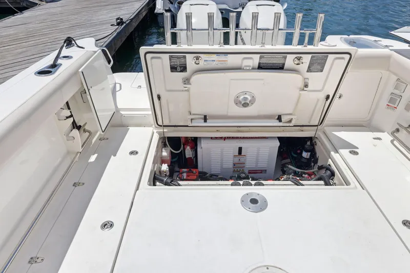 Slide: The Image of 2018 Boston Whaler 315 Conquest boat engine compartment open at dock. - 18