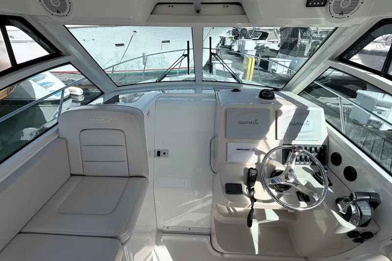 Slide: The Image of 2018 Boston Whaler 315 Conquest helm with Garmin navigation and Mercury controls. - 31