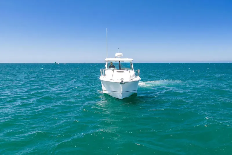 Slide: The Image of 2018 Boston Whaler 315 Conquest cruising on open blue ocean waters. - 79