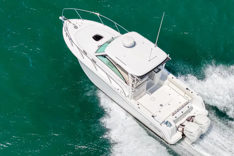 Slide: The Image of 2018 Boston Whaler 315 Conquest cruising on turquoise waters, aerial view. - 61