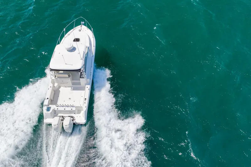 Slide: The Image of 2018 Boston Whaler 315 Conquest cruising on open water, aerial view. - 69