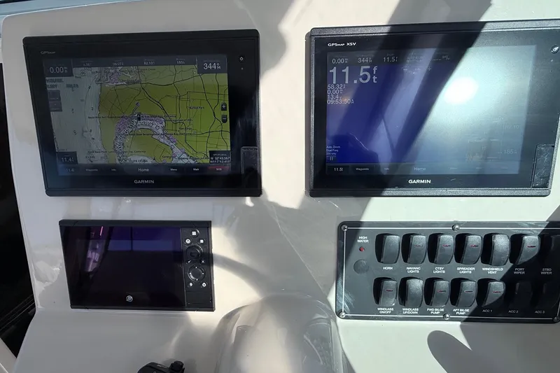 Slide: The Image of Control panel of a 2018 Boston Whaler 315 Conquest with Garmin navigation displays. - 8