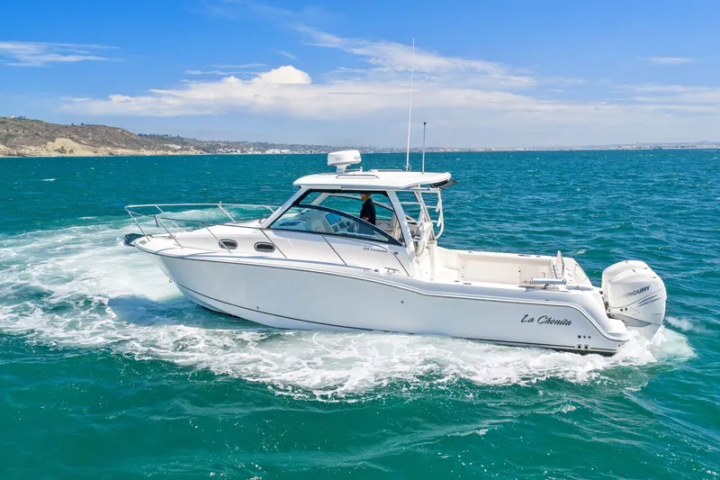 Slide: The Image of 2018 Boston Whaler 315 Conquest cruising on blue ocean waters under clear skies. - 84