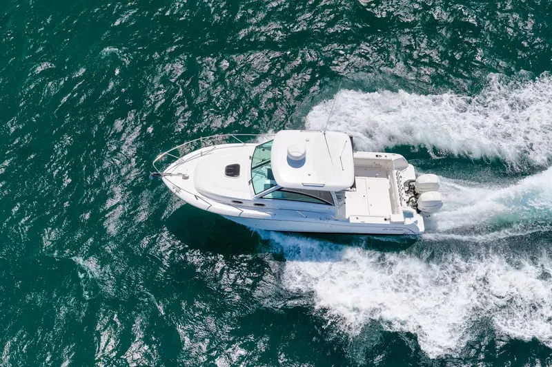Slide: The Image of Aerial view of 2018 Boston Whaler 315 Conquest cruising on vibrant blue ocean waters. - 73