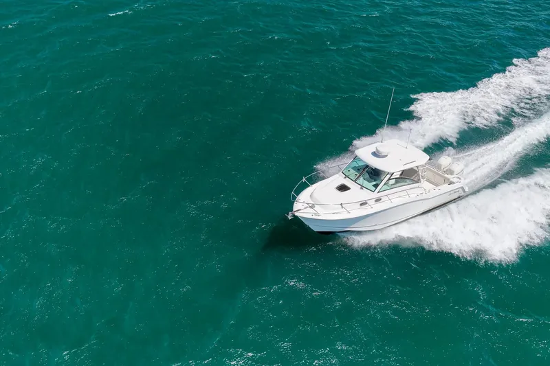 Slide: The Image of 2018 Boston Whaler 315 Conquest cruising on vibrant turquoise waters. - 56
