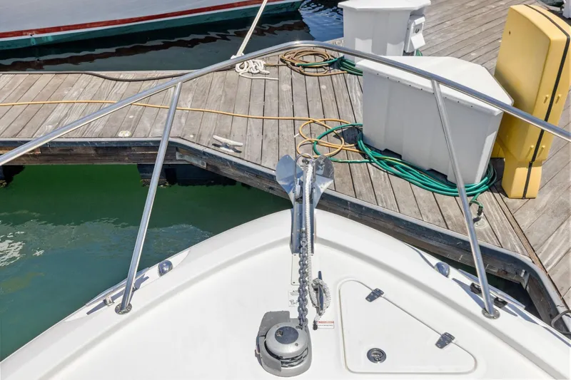 Slide: The Image of Bow view of 2018 Boston Whaler 315 Conquest docked, showcasing anchor and deck details. - 30