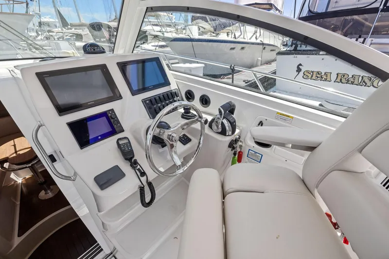 Slide: The Image of 2018 Boston Whaler 315 Conquest helm with modern navigation displays and controls. - 25