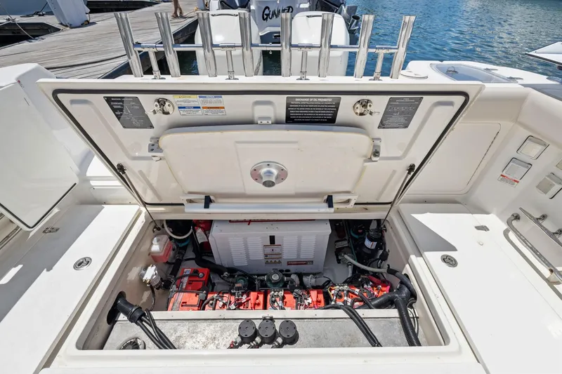 Slide: The Image of 2018 Boston Whaler 315 Conquest engine compartment, showcasing detailed mechanical components. - 19