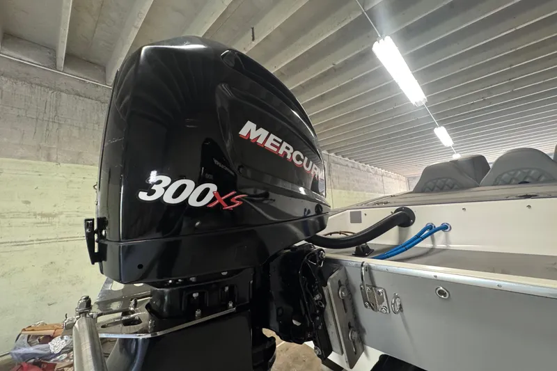 Slide: The Image of Mercury 300XS outboard motor on 1990 Skater 24 boat in a garage. - 14