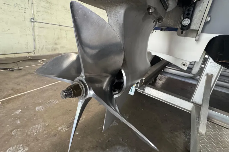 Slide: The Image of Close-up of a Skater 24 boat propeller, model year 1990, in a workshop setting. - 19